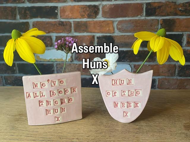 Ange’s pink hand-built slogan pots with yellow flowers